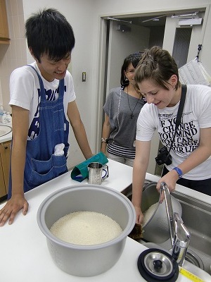 Master KCP students learning to cook rice