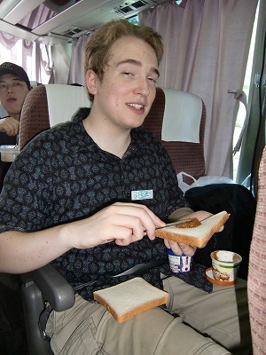 Fuji-3 KCP student having a meal on the bus.