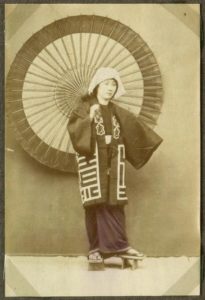 Woman in kimono and red wagasa, circa 1888.