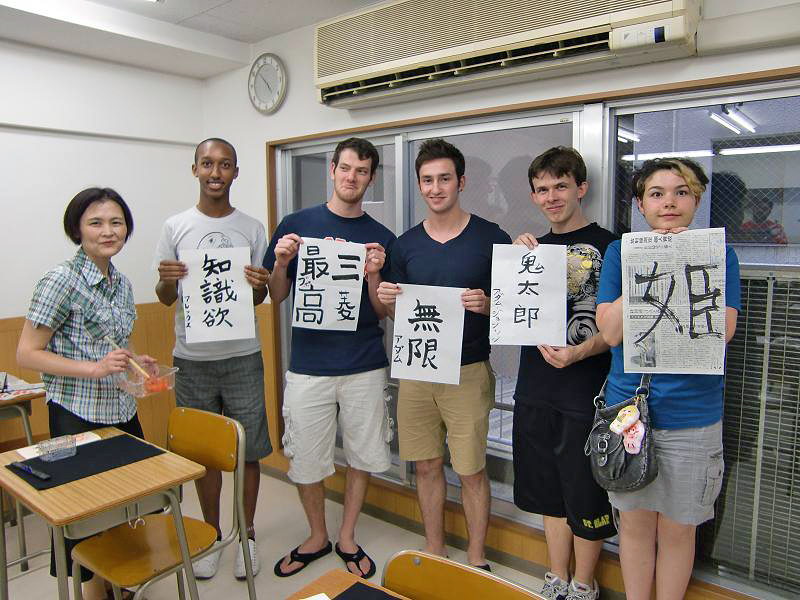 KCP students in holding up Japanese characters they learned.